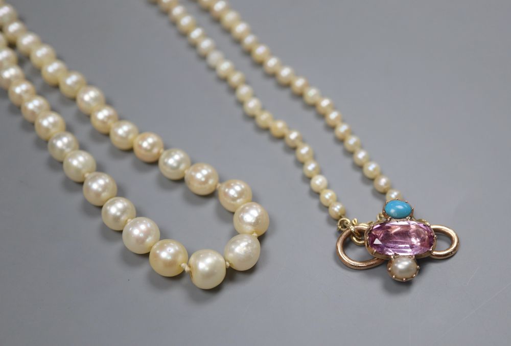 A single strand graduated cultured pearl necklace with yellow metal and gem set clasp (ex. ring head?), 74cm.